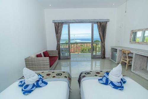 Postel nebo postele na pokoji v ubytování Grand Sea View Lembongan