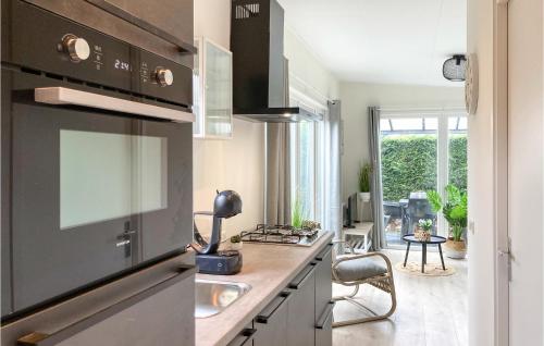 a kitchen with a sink and a stove top oven at 2 Bedroom Stunning Home In Heinkenszand in Heinkensand