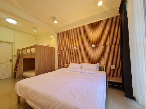 a bedroom with a large bed and a bunk bed at De Chalet in Bangkok