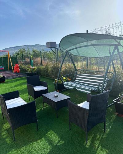 a group of chairs and tables on a lawn at Hotel Tatul in Momchilgrad