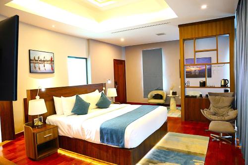 a hotel room with a bed and a chair at Castle Bayview Resort & Spa in Kampot