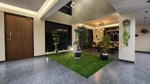 a lobby with a room with potted plants in it at Dolce Villa IGATPURI in Igatpuri