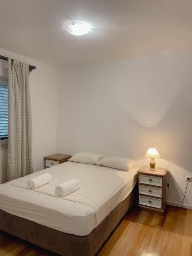 a bedroom with a bed and a lamp and a window at Prizba Tomas One in Blato