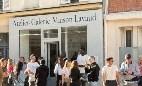 a group of people standing outside of a building at Maison Lavaud in Paris