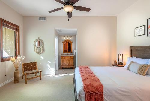 a bedroom with a bed and a ceiling fan at The Oaktree Estate by Fieldtrip 7 Acre Private Resort with Lake Pool Vineyard in Lake Elsinore