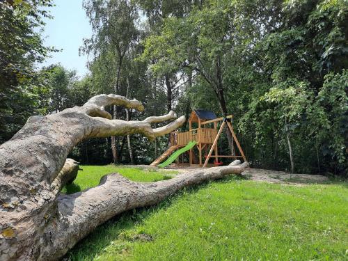 a tree branch laying on the ground next to a playground at 33 Mini Pod "Ostsee" in Silberstedt