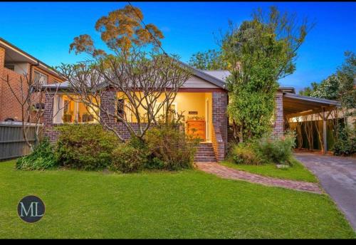 a home with a brick house with a driveway at Kirkwood in Castle Hill
