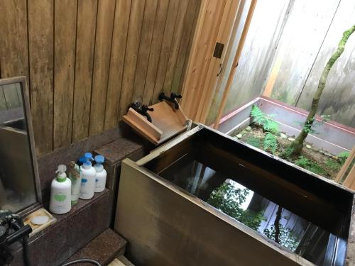a bathroom with a sink with bottles in it at 金文堂 kinbundo in Himi