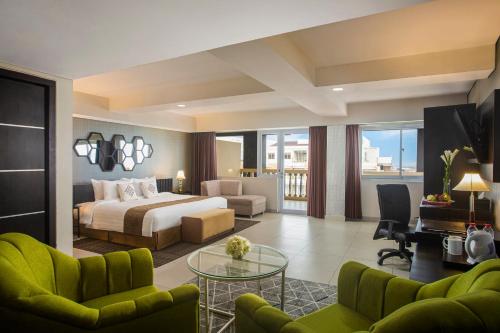 a hotel room with a bed and a table at Merapi Merbabu Hotel Yogyakarta Powered by Archipelago in Yogyakarta