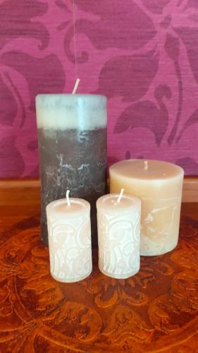 three candles sitting on top of a table at The Oaks- a beautifully appointed 1890s villa in Featherston