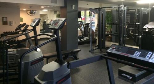 a gym with several treadmills and a treadmill at Hotel Faubourg Montreal Centre-Ville Downtown in Montréal