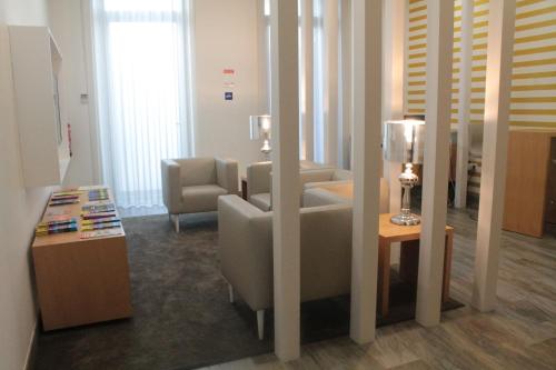 a living room with a couch and a chair and a table at Seculo Soft in Porto