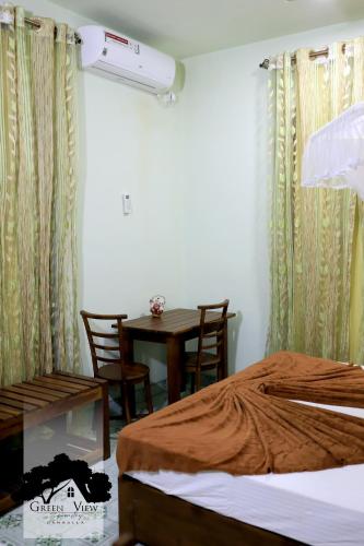 a room with a table and a bed and a dining room at Green View in Dambulla