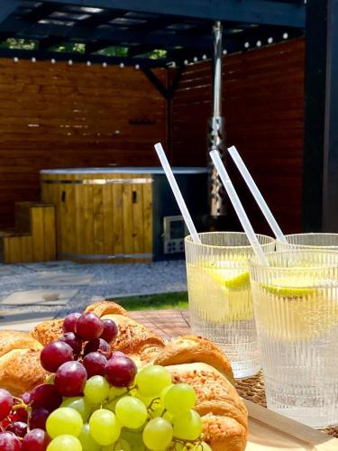 a table with bread and glasses of water and grapes at H&Z Radawa in Radawa