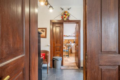 a hallway with a door leading to a dining room at Chalupa Ema Nikol in Rovensko pod Troskami
