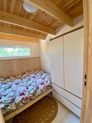 a small bedroom with a bed and a window at H&Z Radawa in Radawa