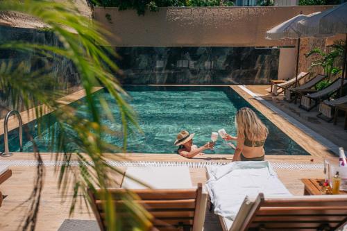 two people sitting in a swimming pool at Los Suites in Antalya