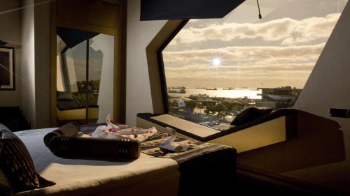 a bedroom with a view of a city from a window at Rios Edition Hotel in Istanbul