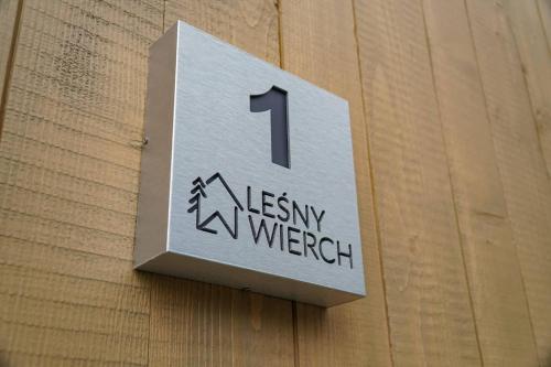 a sign on a wall with the number one on it at Leśny Wierch luxury spa villas in Bukowina Tatrzańska