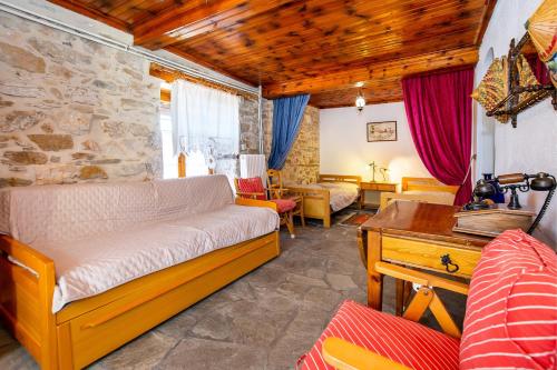 a living room with a couch and a table at Etherio House in Skala Sotiros