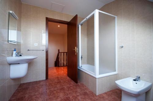a bathroom with a sink and a shower and a toilet at U-Hotel Darío Lugo in Lugo