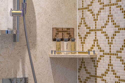 a shower in a bathroom with a tile wall at Zhaolin Grand Hotel in Beijing