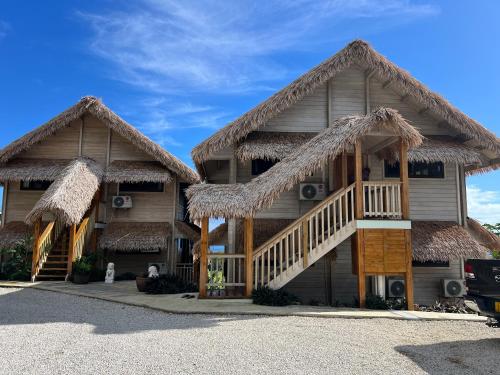 a resort building with a thatched roof at The Links in Rarotonga