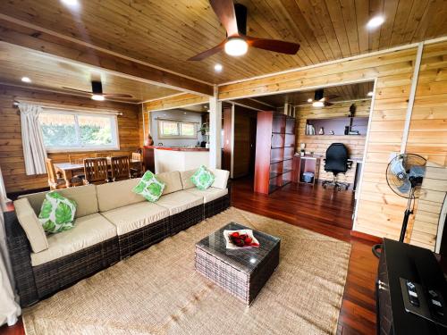 a living room with a couch and a table at The Links in Rarotonga