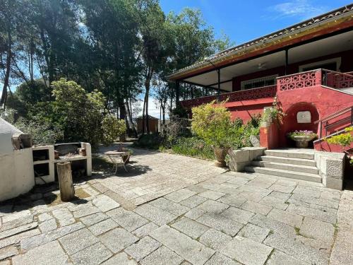 a building with a stone patio in front of it at Casa Rural Los Menhires in Torrejón de Ardoz