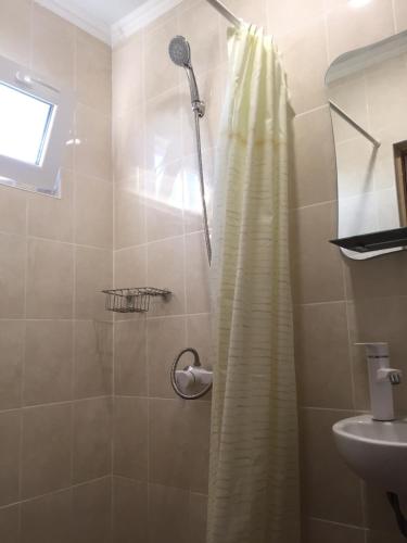 a bathroom with a shower with a shower curtain at Дача in Zatoka
