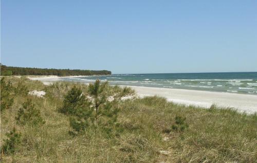 a view of a beach with the ocean in the background at Holiday Home Stampen Vej in Rønne