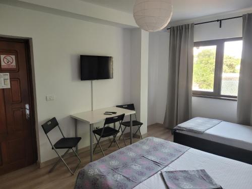 En eller flere senge i et værelse på Vila Dalex