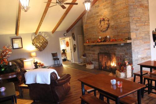a living room with a large stone fireplace at Cliff Dwellers Inn in Blowing Rock