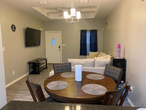a living room with a table and a couch at Cozy Getaway with King Bed near UTRGV in Edinburg
