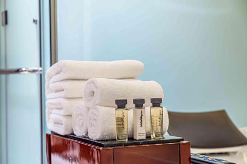 a pile of towels on a shelf in a bathroom at Zhaolin Grand Hotel in Beijing