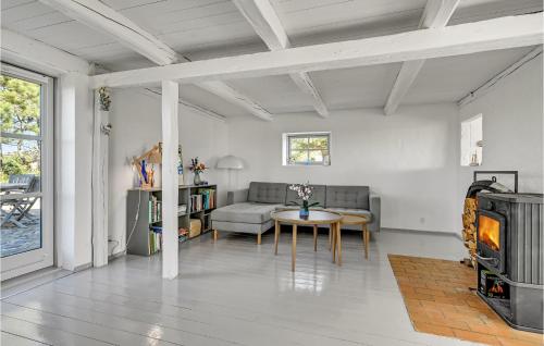 a living room with a table and a couch at Awesome Home In Knebel With Kitchen in Knebel