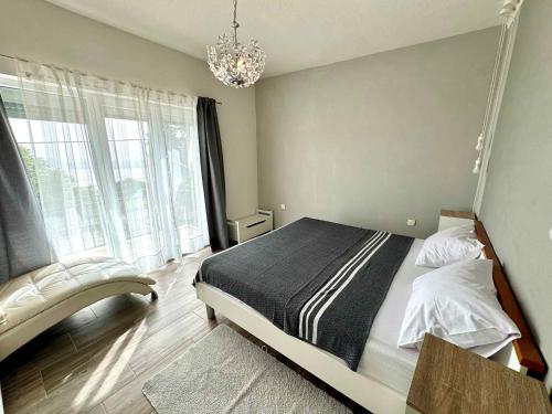 a bedroom with a bed and a chandelier at Apartment in Dramalj 44160 in Dramalj