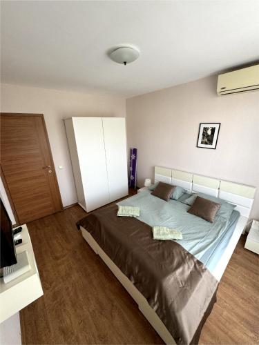 a bedroom with a large bed in a room at Sea view Prestige Fort beach Apartment in Sveti Vlas