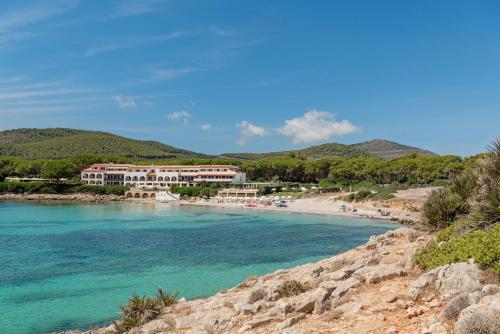a view of a beach with a resort at Hotel Punta Negra in Alghero
