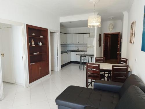 a living room and kitchen with a couch and a table at Puerto Marina in Benalmádena