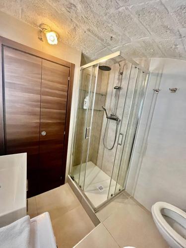 a bathroom with a shower and a toilet at Perla Marina in Monopoli