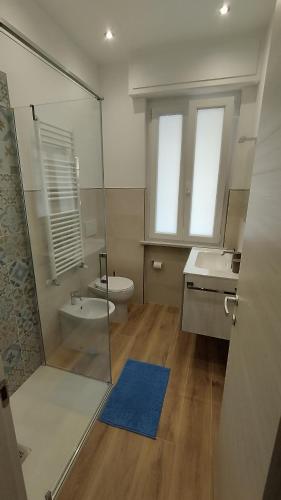 a bathroom with a shower and a toilet and a sink at Conca del Sole in Rapallo