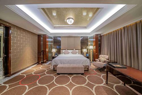 a large bedroom with a bed and a couch at Zhaolin Grand Hotel in Beijing