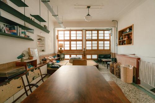 a room with a large wooden table in it at 365.Hostel in Tainan