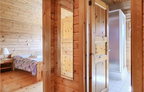 a bedroom with a bed and a wooden wall at Amazing Home In Masserberg in Fehrenbach