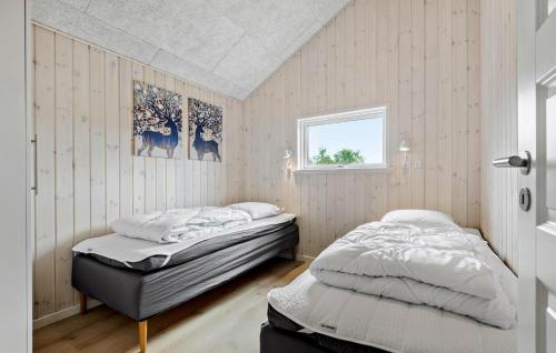 a bedroom with two beds and a window at Amazing Home In Rømø With Wifi in Vesterhede