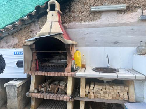 a kitchen with a stove and a sink at Casa Patricia en Fuencaliente con Piscina privada Climatizada in Fuencaliente
