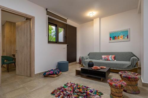 a living room with a couch and a table at Iniada Villas in Chania Town