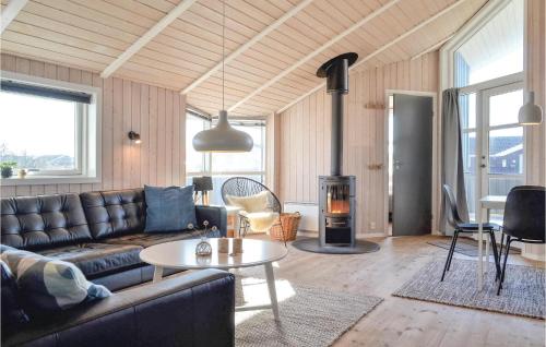 a living room with a couch and a wood stove at Holiday Home Bjerregårdsvej Denm in Bjerregård