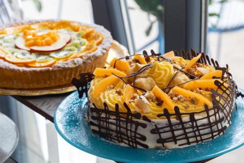 two pies on a blue plate on a table at Selinunte Boutique Hotel in Marinella di Selinunte